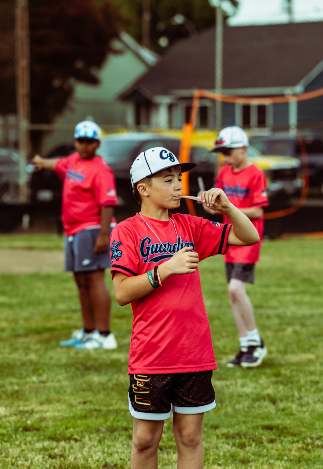 A young ballplayer with his team behind him