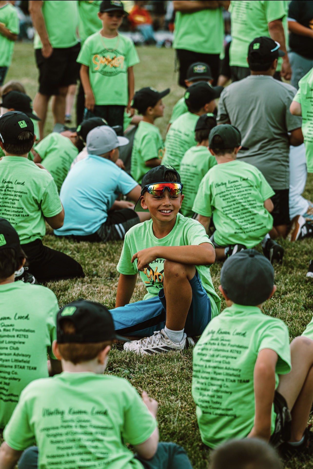 Kids in bright green program shirts on the grass